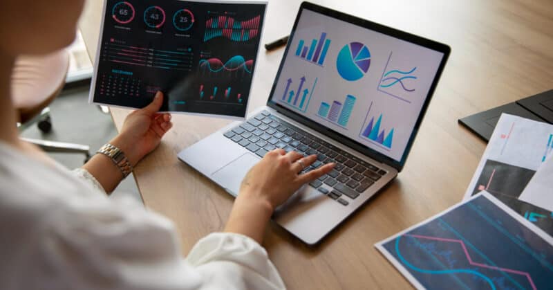 office workers using finance graphs 800x419 1